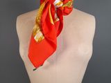 an orange and yellow scarf on a mannequin torso