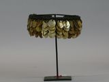a table lamp made out of coins on a metal stand