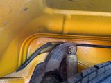 a close up view of a yellow vehicle with a wrench on it