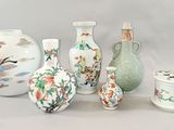 many different vases and containers sitting on a table