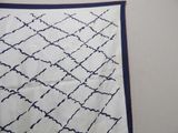 an image of a white and blue scarf with a pattern on it