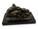 bronze statue of a woman laying on a pillow on a marble base