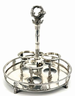 a silver plate with a candle holder on top of it