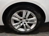 a close up of a white car with a flat tire