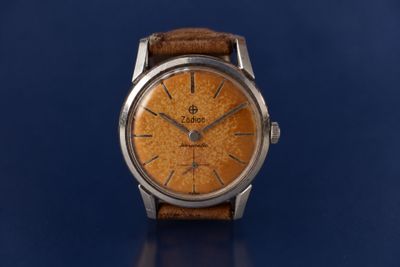 an image of a watch on a blue surface