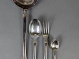 a spoon, fork, spoon and spoon rest on a table