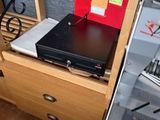 un ordinateur portable posé sur un bureau, à côté d'un classeur