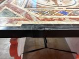 a close up of a marble table with a clock on it