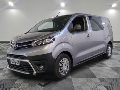the silver van is parked on a checkered floor in a room