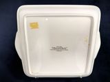 a close up of a white plate on a black surface