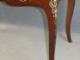 an antique wooden table with a marble top on a white background