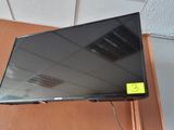 a flat screen tv hanging on a wall in a room