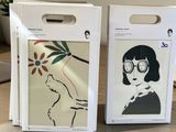 two boxes with a picture of a woman on them sitting on a table