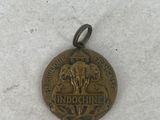 a close up of a medal on a snow covered surface