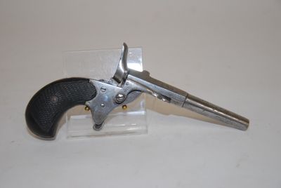 a gun that is sitting on top of a piece of plastic