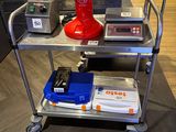 an image of a red coffee machine on a metal cart