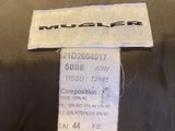 the label on the back of a black jacket with a white label on it