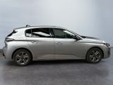 the silver car is parked on the concrete floor in the room