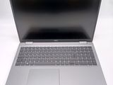 an open laptop computer sitting on top of a white table