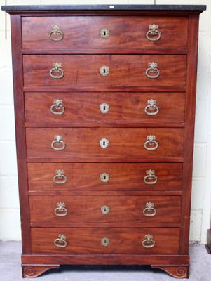 an antique chest of drawers with a marble top and brass pulls