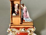 a figurine of a man and a woman in a carriage