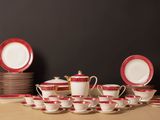 many cups and saucers sitting on a table