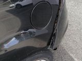 a close up of a car ' s rear end with the door open