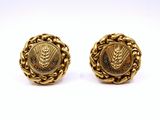 a pair of gold earrings with a lion head on the front and a lion head on the back