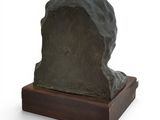 sculpture of a rock on a wooden base on a white background