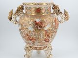 a vase that is sitting on a stand on a white surface