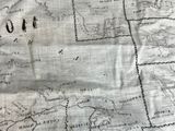 an old map of the world on a piece of cloth