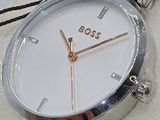 a silver watch with a white face on a white box