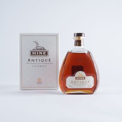 an image of a bottle of wine next to a box on a white surface