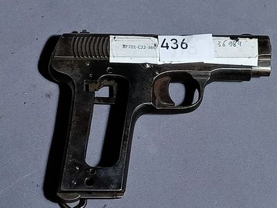 a gun with a tag on it on a table