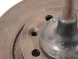 a close up of a metal object on a white surface