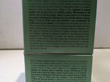 a close up of a green box on a white surface