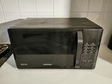a black microwave sitting on a counter in a kitchen