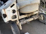 a cement mixer that is sitting in the driveway