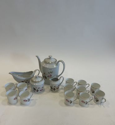 a lot of cups and saucers sitting on a table