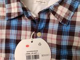 a close up of a button down shirt with a price tag on it