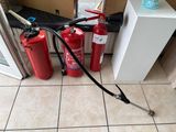 three fire extinguisors sitting on the floor next to each other