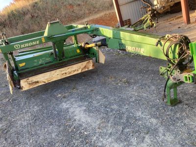 une machine verte qui est à l'arrêt dans la boue
