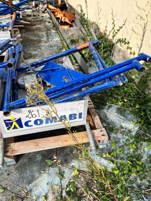 a pile of blue construction equipment sitting on the side of a building