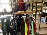 a rack of clothes in a room with a lot of shelves