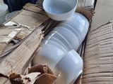 a pile of boxes and a bowl on a table