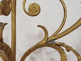 a gold metal candle holder with a bird on it
