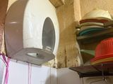 a picture of a bathroom with a toilet paper dispenser on the wall