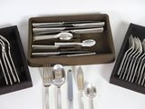 a lot of silverware in a box on the table