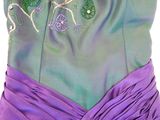 the back of a purple and green dress with flowers on it