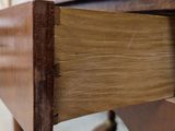 a close up of a wooden desk with a drawer on it